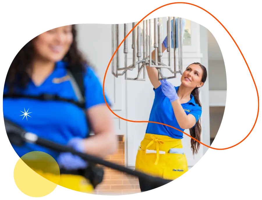 2 team members from The Maids cleaning a kitchen
